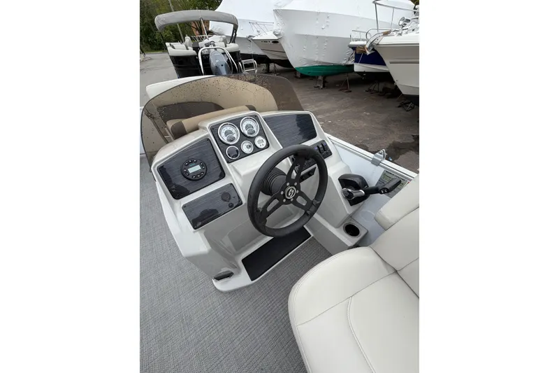 Slide: The Image of 2023 Sylvan Mirage 820 LZ boat dashboard with steering wheel and control panel. - 8