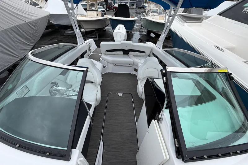 Slide: The Image of 2023 Four Winns HD5 OB boat interior with white captain's seat and steering wheel. - 15