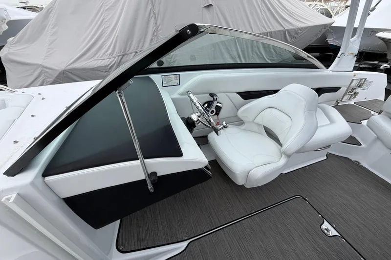 Slide: The Image of 2023 Four Winns HD5 OB boat cockpit with white seating and modern controls. - 16
