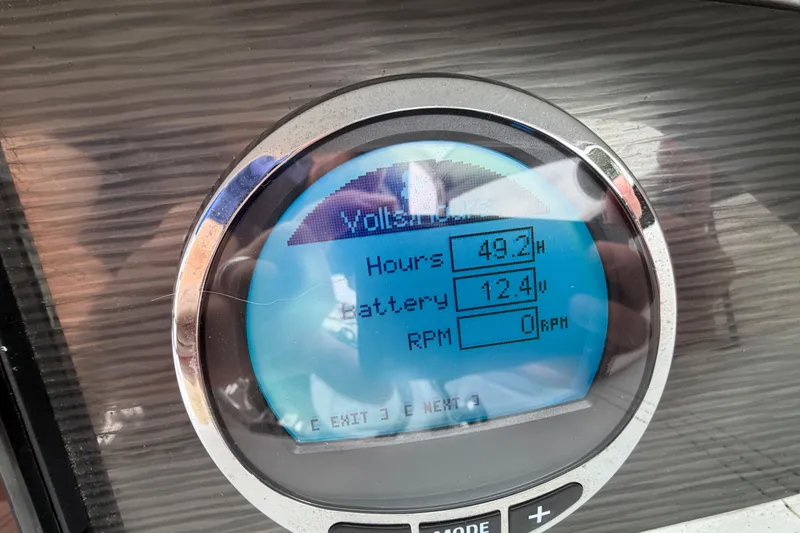 Slide: The Image of 2023 Four Winns HD5 OB boat dashboard with Simrad navigation display and gauges. - 19