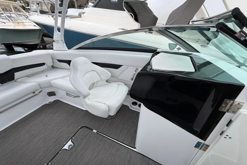 Slide: The Image of 2023 Four Winns HD5 OB boat interior with luxurious white seating and modern design. - 21