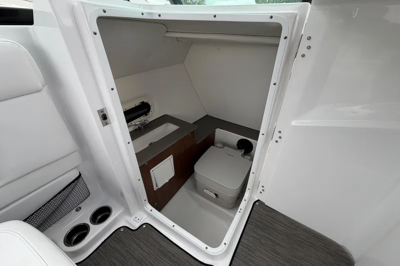Slide: The Image of 2023 Four Winns HD5 OB boat interior with sink, countertop, and wall light. - 23