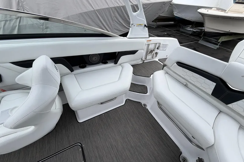 Slide: The Image of 2023 Four Winns HD5 OB boat interior with open storage compartment and white seating. - 27