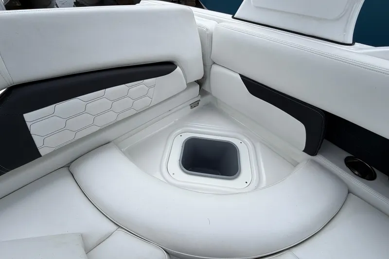 Slide: The Image of 2023 Four Winns HD5 OB boat interior with storage compartment and white seating. - 29