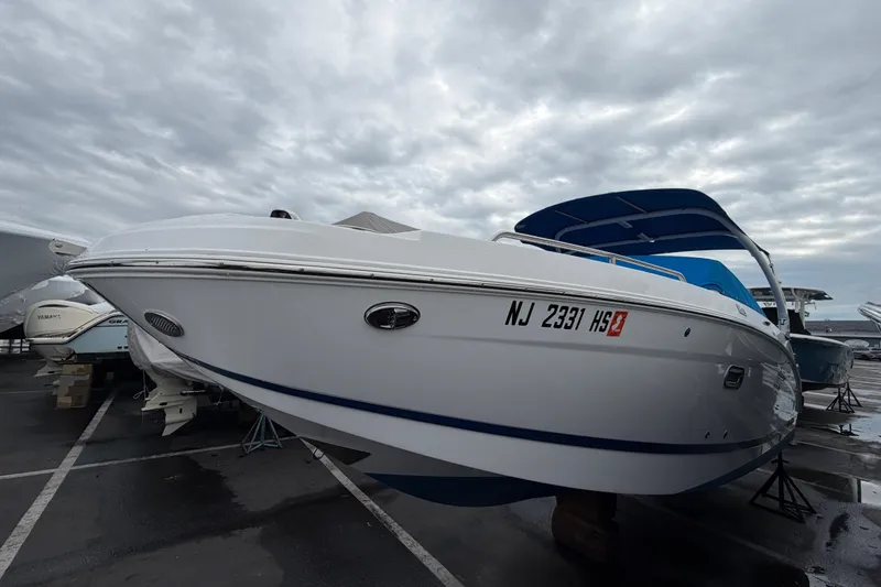 Slide: The Image of 2023 Four Winns HD5 OB boat with Mercury outboard engine, blue canopy, and cover. - 3