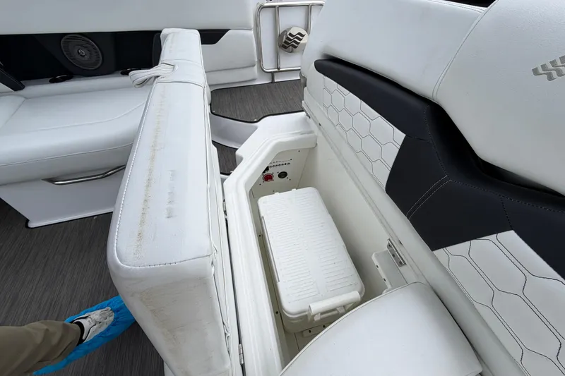 Slide: The Image of 2023 Four Winns HD5 OB boat interior with storage compartment and speaker. - 30
