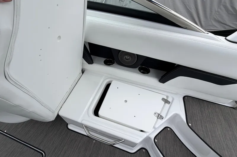 Slide: The Image of 2023 Four Winns HD5 OB boat interior storage compartment with speaker and cup holders. - 31