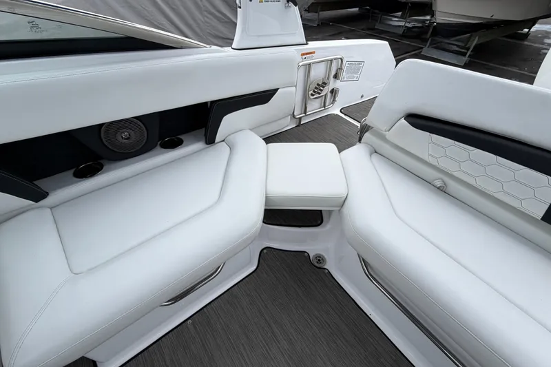 Slide: The Image of 2023 Four Winns HD5 OB boat interior with white seating and blue canopy. - 33