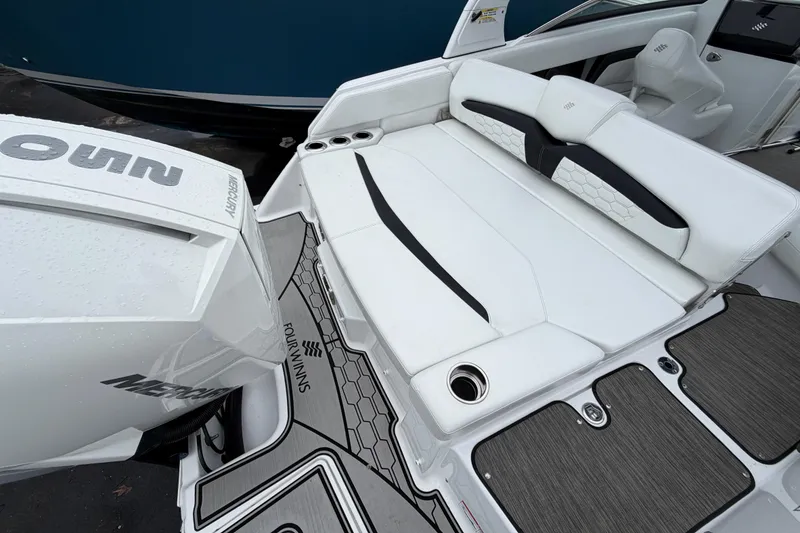 Slide: The Image of 2023 Four Winns HD5 OB boat interior with white seating and cup holders. - 36