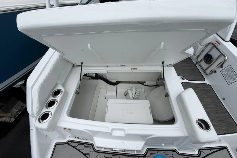 Slide: The Image of Storage compartment of 2023 Four Winns HD5 OB boat with cooler and cables. - 38