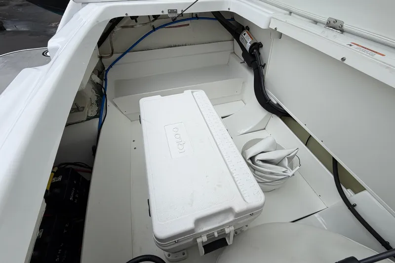Slide: The Image of Storage compartment of 2023 Four Winns HD5 OB boat with cooler and accessories. - 39