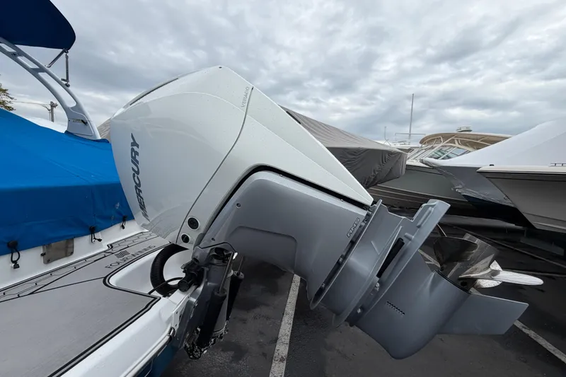Slide: The Image of 2023 Four Winns HD5 OB boat with Mercury outboard motor in a marina. - 42