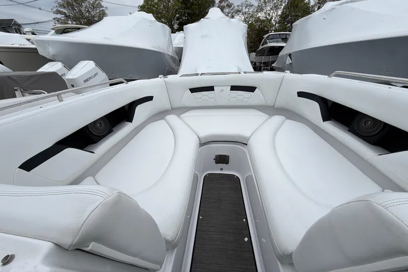 Slide: The Image of 2023 Four Winns HD5 OB boat interior with white cushioned seating. - 5