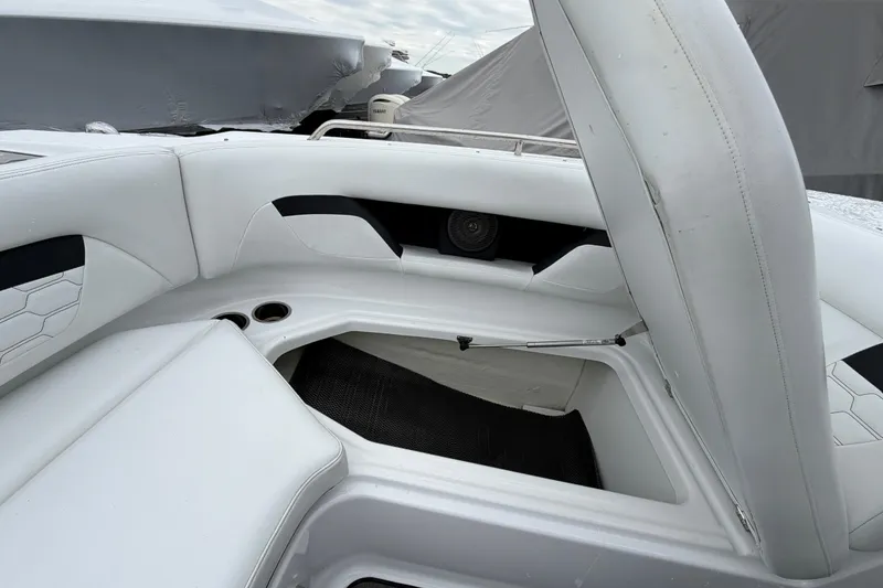 Slide: The Image of 2023 Four Winns HD5 OB boat interior with white cushioned seating. - 7