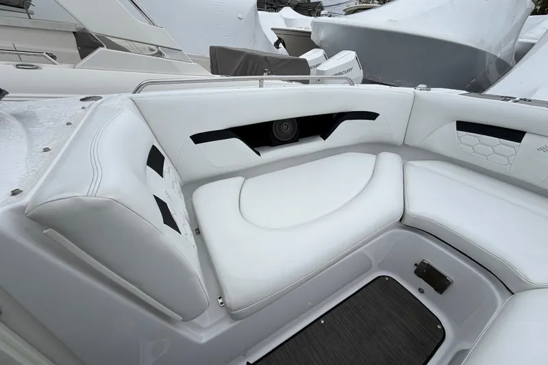 Slide: The Image of 2023 Four Winns HD5 OB boat interior with white seating and cup holders. - 8