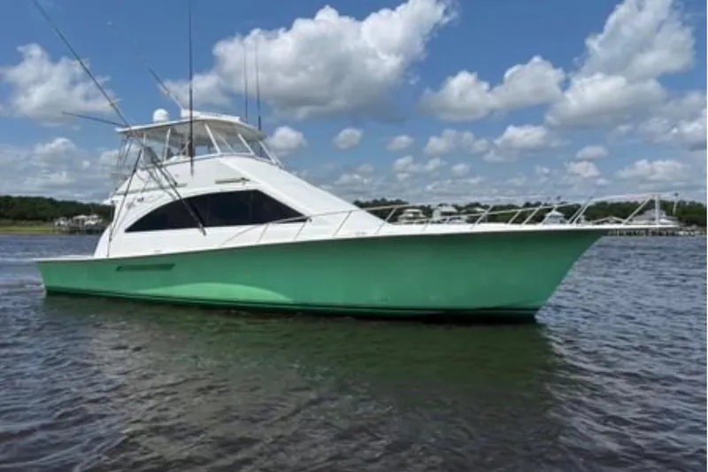 The Image of 1999 Ocean Yachts 56 Super Sport boat on water under blue sky. - 0