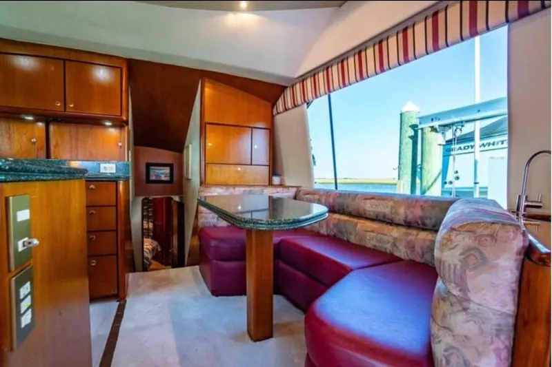 Slide: The Image of Luxurious interior of 1999 Ocean Yachts 56 Super Sport with elegant seating and wood cabinetry. - 7