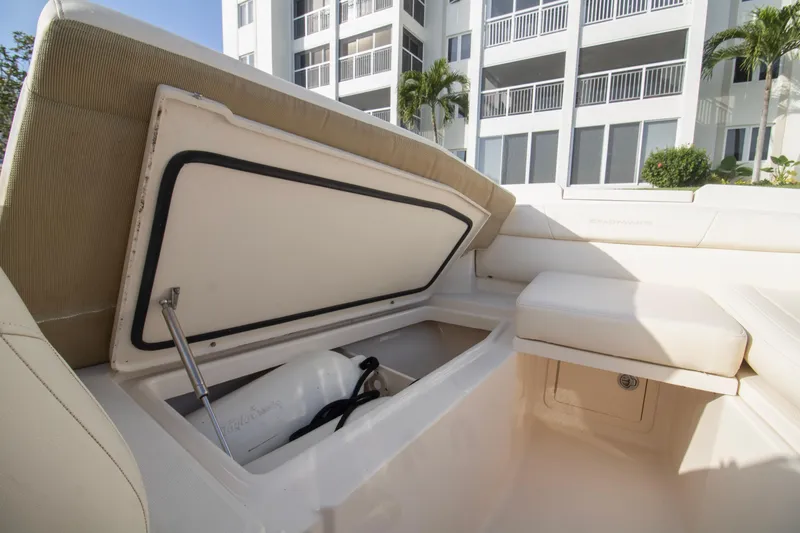 Slide: The Image of 2020 Grady-White Freedom 285 boat storage compartment open near modern building. - 11