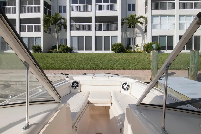 Slide: The Image of 2020 Grady-White Freedom 285 boat docked near waterfront apartments. - 12