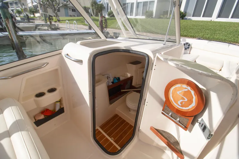 Slide: The Image of 2020 Grady-White Freedom 285 boat interior with open cabin door and seating area. - 15