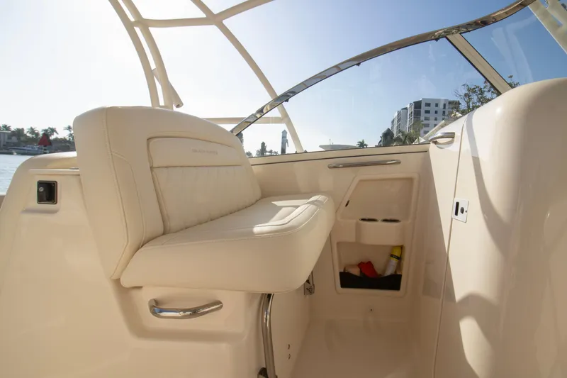 Slide: The Image of 2020 Grady-White Freedom 285 boat interior with beige seating and storage compartments. - 17