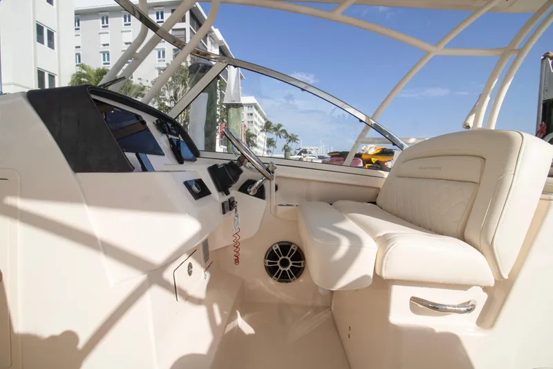Slide: The Image of 2020 Grady-White Freedom 285 boat interior with steering wheel and seating. - 19