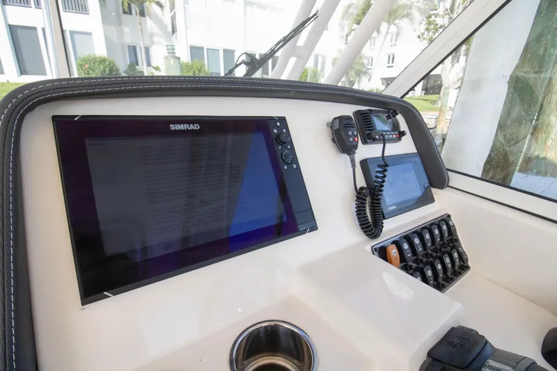 Slide: The Image of 2020 Grady-White Freedom 285 boat dashboard with Simrad display and controls. - 22