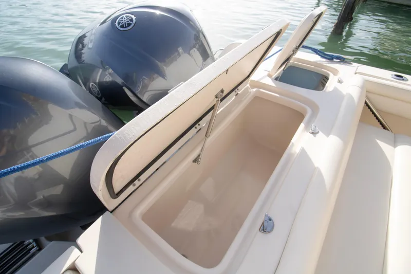 Slide: The Image of 2020 Grady-White Freedom 285 boat with open storage compartments and dual engines. - 26