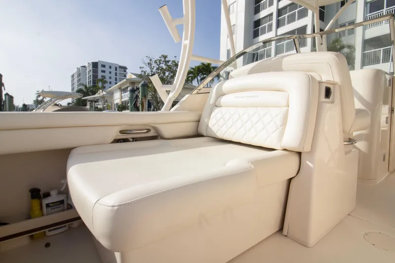 Slide: The Image of Luxurious seating on 2020 Grady-White Freedom 285 boat, docked near modern buildings. - 31