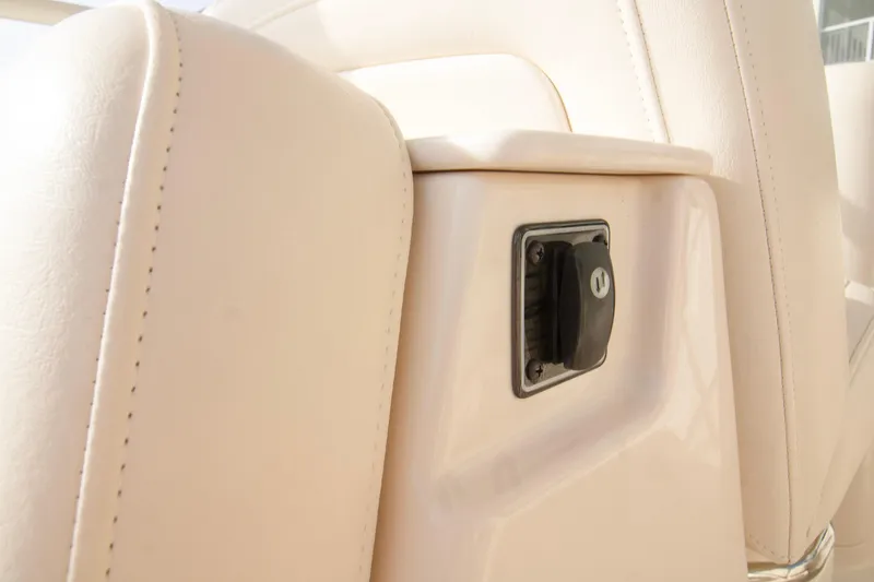 Slide: The Image of Close-up of 2020 Grady-White Freedom 285 boat interior with beige upholstery and a control switch. - 32