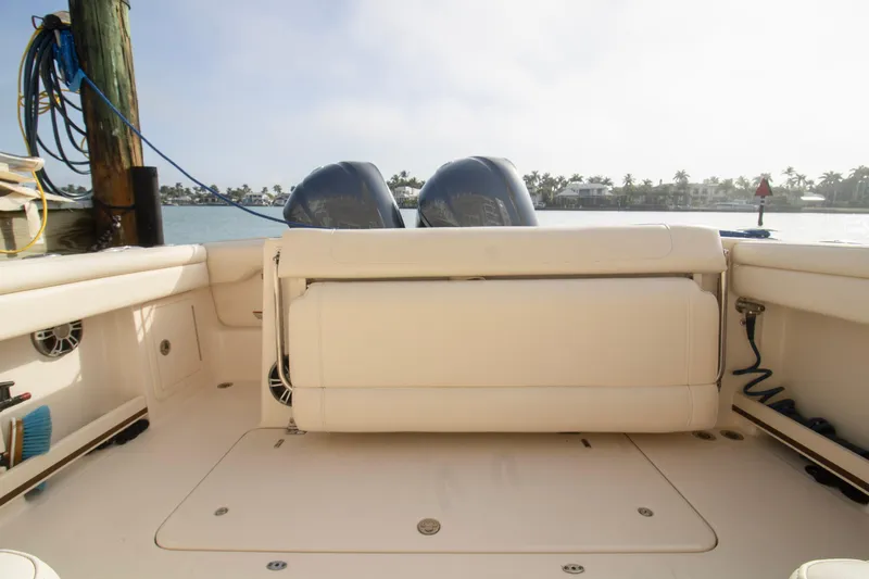 Slide: The Image of 2020 Grady-White Freedom 285 boat interior with dual engines, docked by the water. - 33