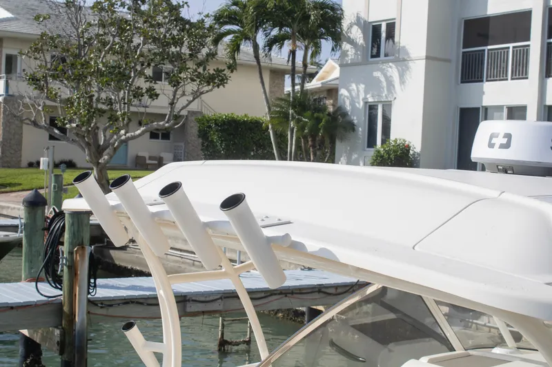 Slide: The Image of 2020 Grady-White Freedom 285 boat with rod holders, docked near waterfront buildings. - 34