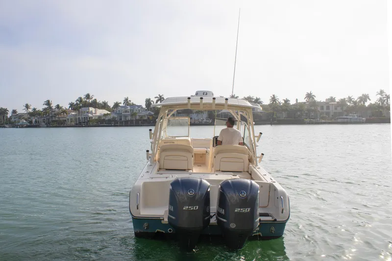 Slide: The Image of 2020 Grady-White Freedom 285 boat cruising on a sunny day near waterfront homes. - 4