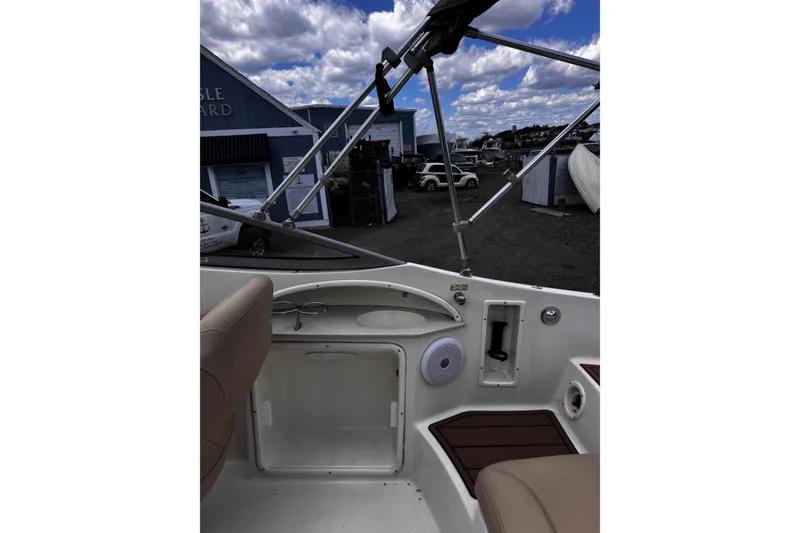Slide: The Image of Interior view of a 2015 Stingray 234 LR boat with seating and storage compartments. - 14