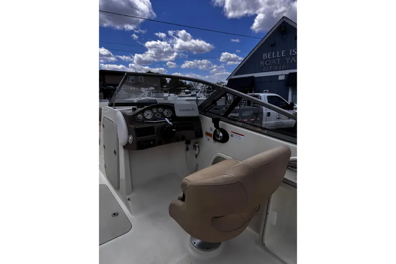 Slide: The Image of 2015 Stingray 234 LR boat interior with steering wheel and dashboard at Belle Isle Boat Yard. - 17