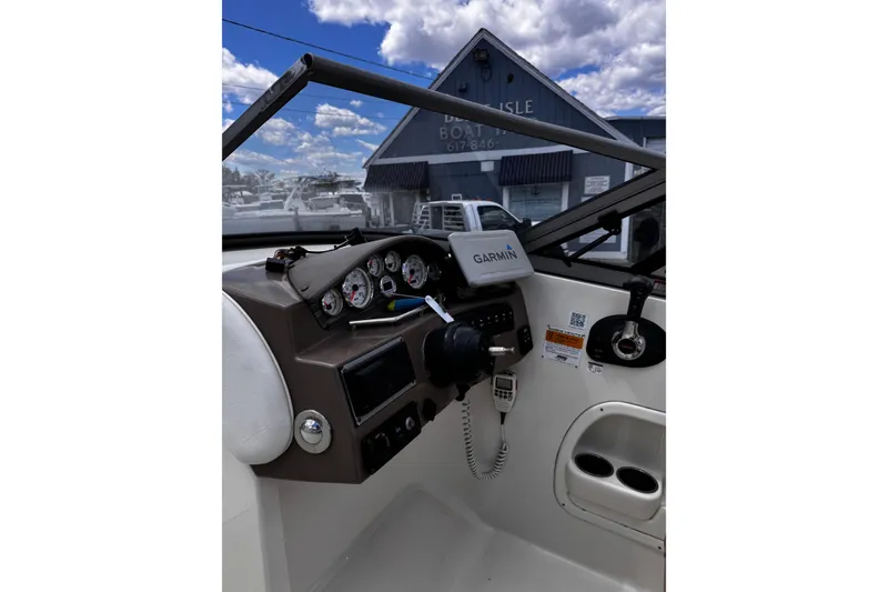 Slide: The Image of 2015 Stingray 234 LR boat dashboard with Garmin GPS, gauges, and controls. - 20