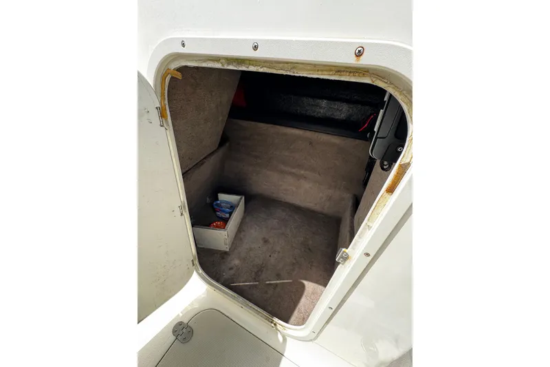 Slide: The Image of Interior storage compartment of a 2015 Stingray 234 LR boat, showing carpeted space. - 22