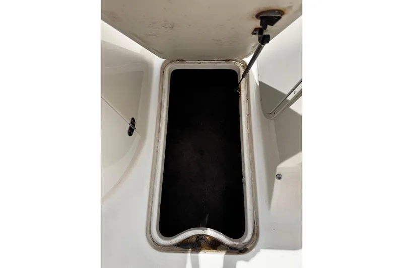 Slide: The Image of Open storage compartment on a 2015 Stingray 234 LR boat. - 23