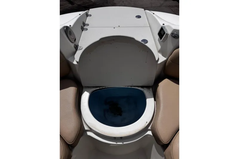 Slide: The Image of 2015 Stingray 234 LR boat interior with seating and storage compartment. - 25