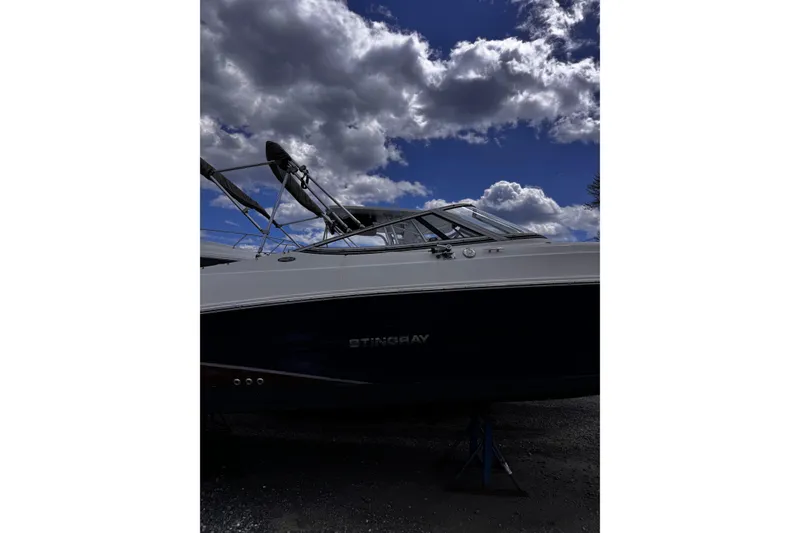 Slide: The Image of 2015 Stingray 234 LR boat under cloudy sky, side view. - 6