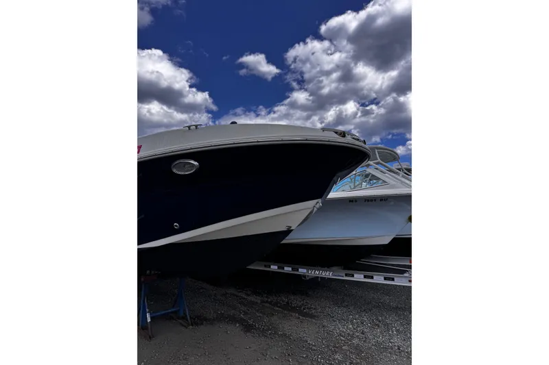 Slide: The Image of 2015 Stingray 234 LR boat on trailer under cloudy sky. - 8