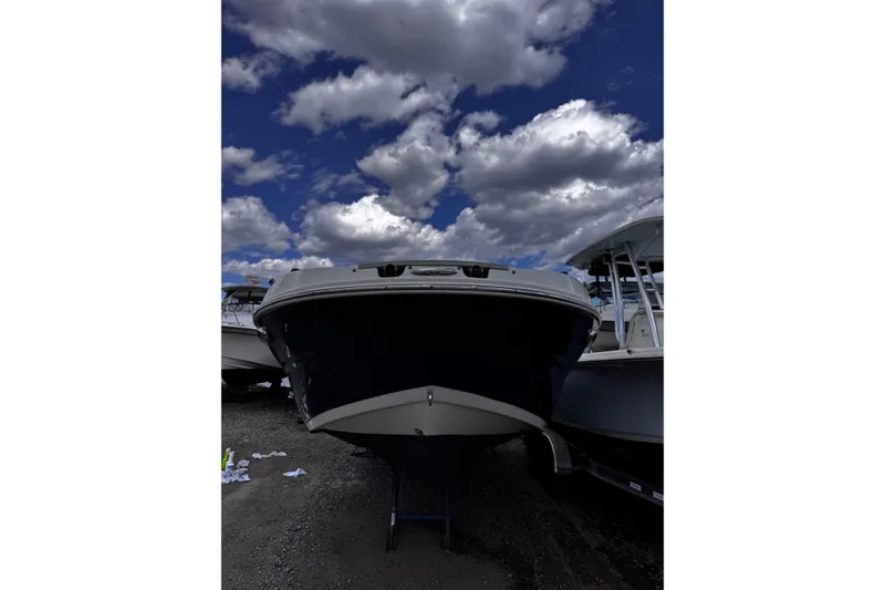 Slide: The Image of 2015 Stingray 234 LR boat under cloudy sky, front view. - 9