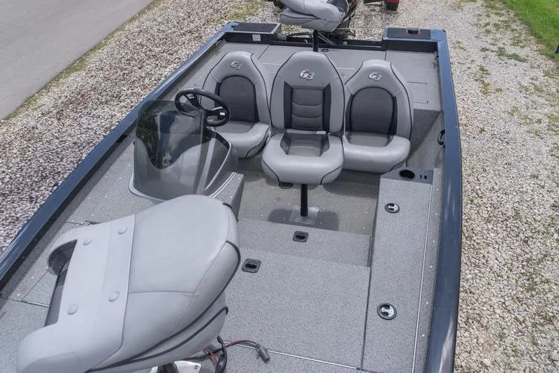 Slide: The Image of 2019 G3 Sportsman 1710 boat interior with gray seating and steering console. - 16