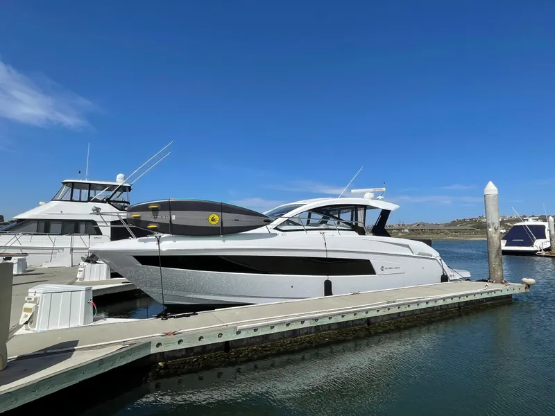 Slide: The Image of 2020 Cruisers Yachts 390 Express Coupe docked, blue sky. - 1
