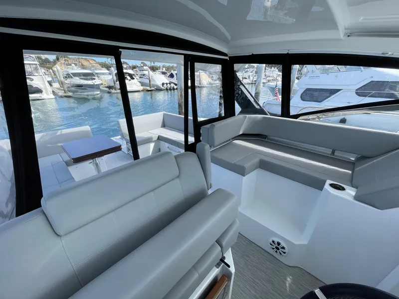 Slide: The Image of Interior of 2020 Cruisers Yachts 390 Express Coupe with marina view. - 12