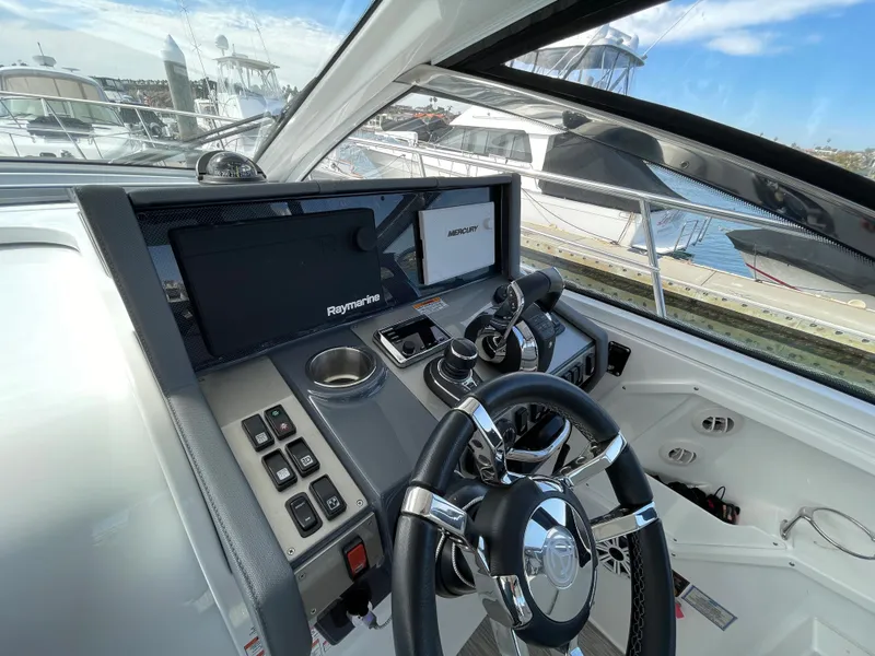 Slide: The Image of 2020 Cruisers Yachts 390 Express Coupe cockpit with modern controls. - 15