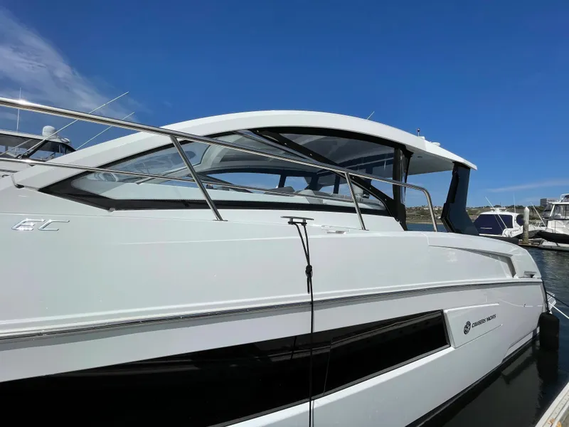 Slide: The Image of 2020 Cruisers Yachts 390 Express Coupe docked, side view. - 2