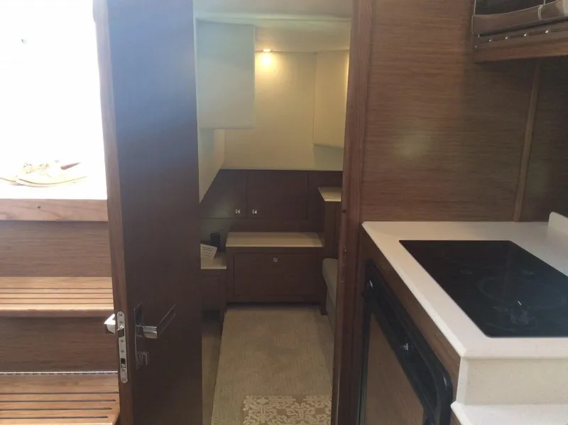 Slide: The Image of Interior of 2020 Cruisers Yachts 390 Express Coupe, featuring modern kitchen and living area. - 25