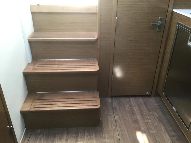 Slide: The Image of Interior of 2020 Cruisers Yachts 390 Express Coupe with wooden stairs. - 29