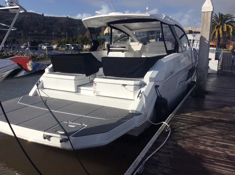 Slide: The Image of 2020 Cruisers Yachts 390 Express Coupe docked, sleek design. - 4
